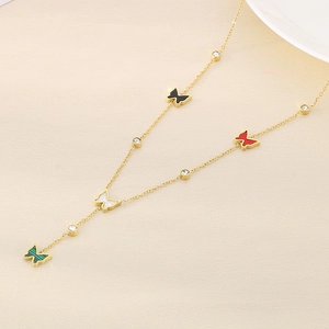 Detail of gold necklace featuring colorful butterfly charms and sparkling zircon accents