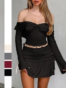 Y2K style slim fit off-shoulder long sleeve black top and ruffled mini skirt set