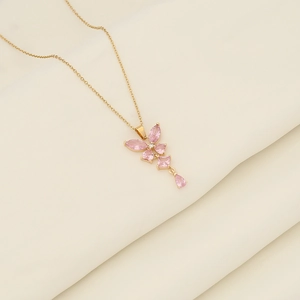 Elegant gold stainless steel necklace with pink gemstone butterfly tassel pendant on beige silk