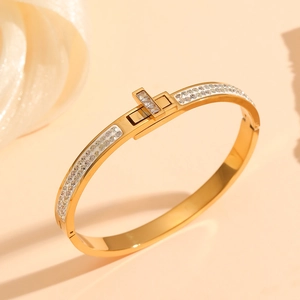 Close-up of gold-plated titanium steel bracelet with pavé cubic zirconia and buckle