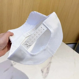 Detail of white baseball cap showing snapback buckle and breathable mesh structure