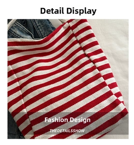 Close-up of red and white striped canvas tote bag showing twill weave and casual style