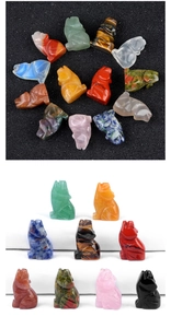 Various hand-carved natural crystal wolf figurines in diverse gemstones and colors