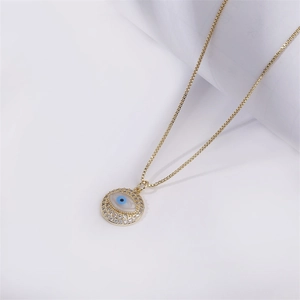 Golden box chain necklace featuring a round micro-pave zircon evil eye pendant design