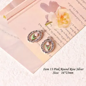 Detailed macro view of 16x23mm silver flower pendant with pink tulip enamel for DIY jewelry