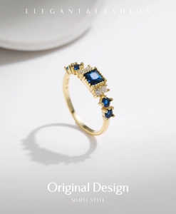 Detailed macro view of S925 silver gold ring with square blue sapphire and accent diamonds