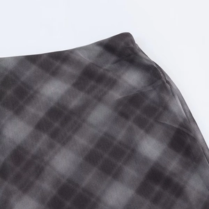 Detail of grey plaid mesh fabric showing fine stitching and transparent sheer texture