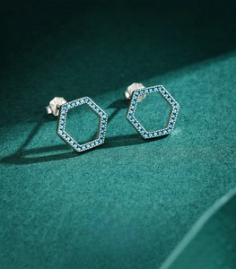 Detailed view of s925 sterling silver hexagonal stud earrings with blue turquoise inlay