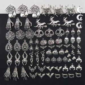 Macro detail of assorted silver Halloween metal charms including pumpkins and spiders