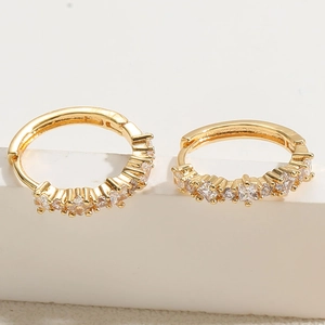 Detail of 14K gold plated hoop earrings featuring a row of sparkling white zircons