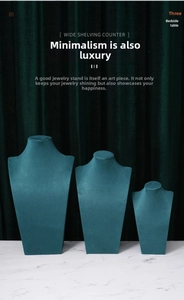 Three-piece tiered set of dark teal velvet bust displays for necklace jewelry shop exhibit