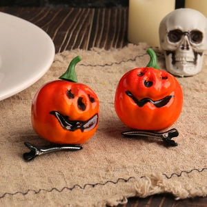 Creative Halloween pumpkin hair clips with smiling faces on a festive burlap background