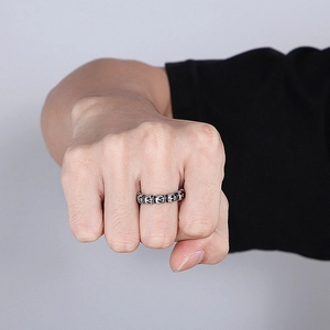 Detailed view of men's retro skull ring with vintage silver finish on hand