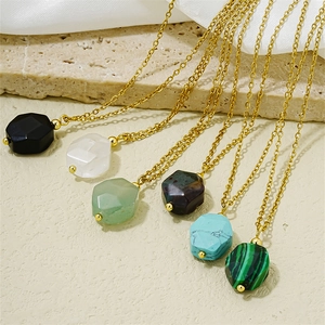 Polygonal natural stone pendants in six colors on golden metal chains displayed on silk