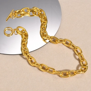 Macro detail of thick 18k gold plated chain link necklace with a polished OT toggle clasp