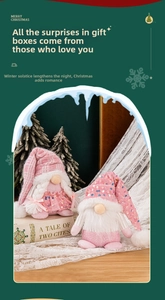 Detail of sequined knit hats on pink Christmas gnomes with warm festive decorations