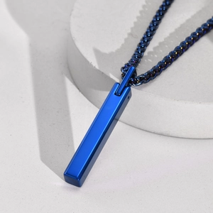 Macro shot of blue tungsten steel bar pendant on a textured white and concrete background
