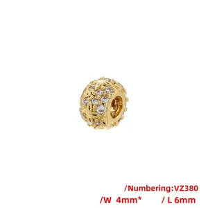 Macro detail of hollow flower pattern bead in gold finish with sparkling cubic zirconia