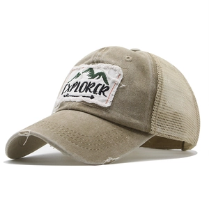 Distressed khaki Explorer trucker hat with mesh back and vintage mountain embroidery