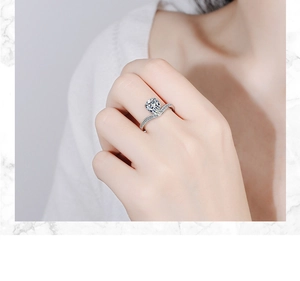 Close-up of a pear-shaped zircon ring with a V-shaped band on a model's finger