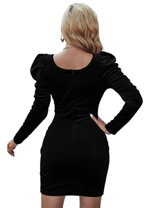 Rear view of slim fit black velvet dress featuring puff sleeves and an open back design