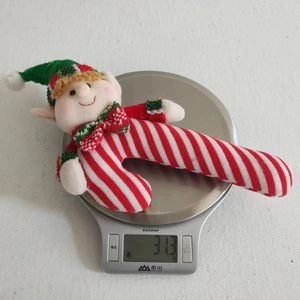 Christmas elf plush on scale showing a light weight of approximately 31.3 grams