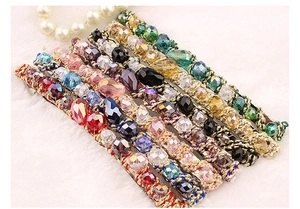 Detailed shot of handmade woven gold thread headbands with colorful crystal beads