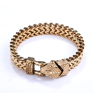 Close-up of golden stainless steel snake head clasp on woven mesh biker bracelet