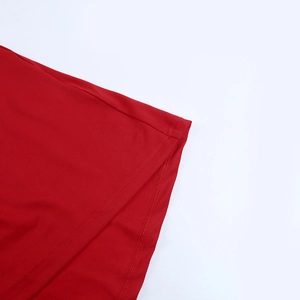 Detailed macro view of the stitching and red fabric of the backless sexy halter dress