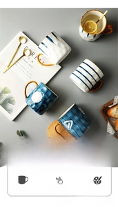 Artistic Japanese ceramic mugs with geometric blue patterns and vibrant gold handles