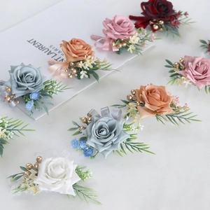 Elegant artificial rose boutonniere set in various colors with green leaves and ribbon