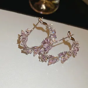 Silver hoop earrings with sparkling lavender and clear zircon butterfly accents