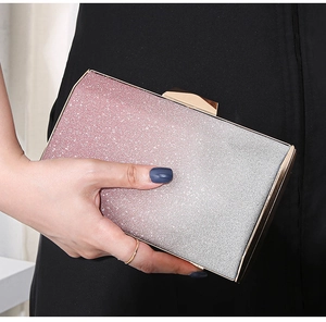 Macro detail of shimmering pink-to-silver gradient glitter on a rigid evening clutch bag