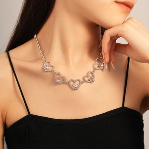 Elegant heart necklace with pink crystals and silver tennis chain on a model