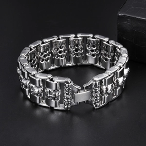 Detailed macro view of punk skull links on heavy silver-tone titanium steel bracelet