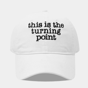 Detailed view of black lettering embroidery on a white washed cotton baseball cap