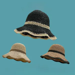 Detailed texture of hand-woven straw hats with wavy brims in three stylish color tones