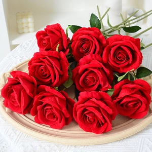 Nine lifelike velvet red artificial roses on a beige tray for elegant home decoration