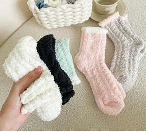 Detail of soft coral fleece socks in multiple colors for winter home comfort
