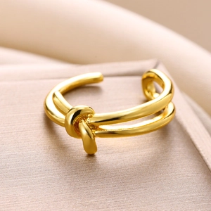 Macro shot of gold double-layer knotted ring with polished finish and open design