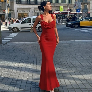 Detail of red bodycon dress featuring elegant draped neckline and chic gold metal rings