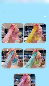 Detail of colorful liquid quicksand keychains with starfish and glitter in star-shaped bottles