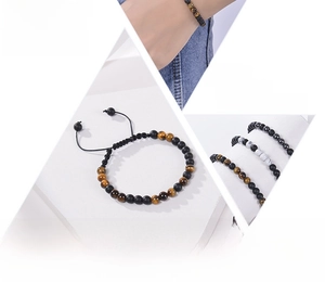 Detailed view of woven Morse code bracelets with tiger eye and matte black beads