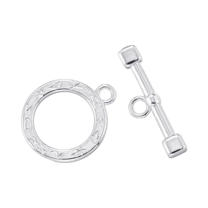 Close-up of vintage silver plated round OT toggle clasp with intricate engraved floral pattern