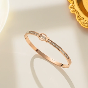 Rose gold titanium steel bracelet featuring full zircon inlay and a central love buckle