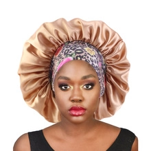 Detail of champagne satin sleep bonnet with leopard and floral patterned headband