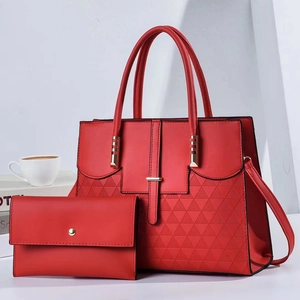 Detail of red tote bag and clutch set with gold hardware and geometric textures