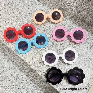Detail view of flower shaped kids sunglasses in various candy colors with UV400 protection