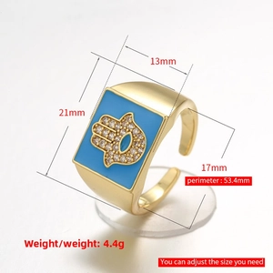 Detailed view of Hamsa signet ring with blue enamel, 21x13mm gold-plated design