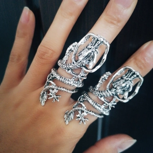 Macro close-up showing detailed dragon scales and engraving on silver punk ring
